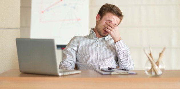 Tired man at work (iStock)